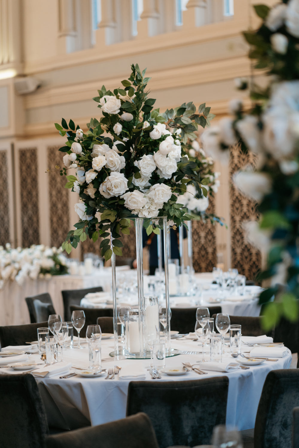 Tall wedding centerpiece with white roses.