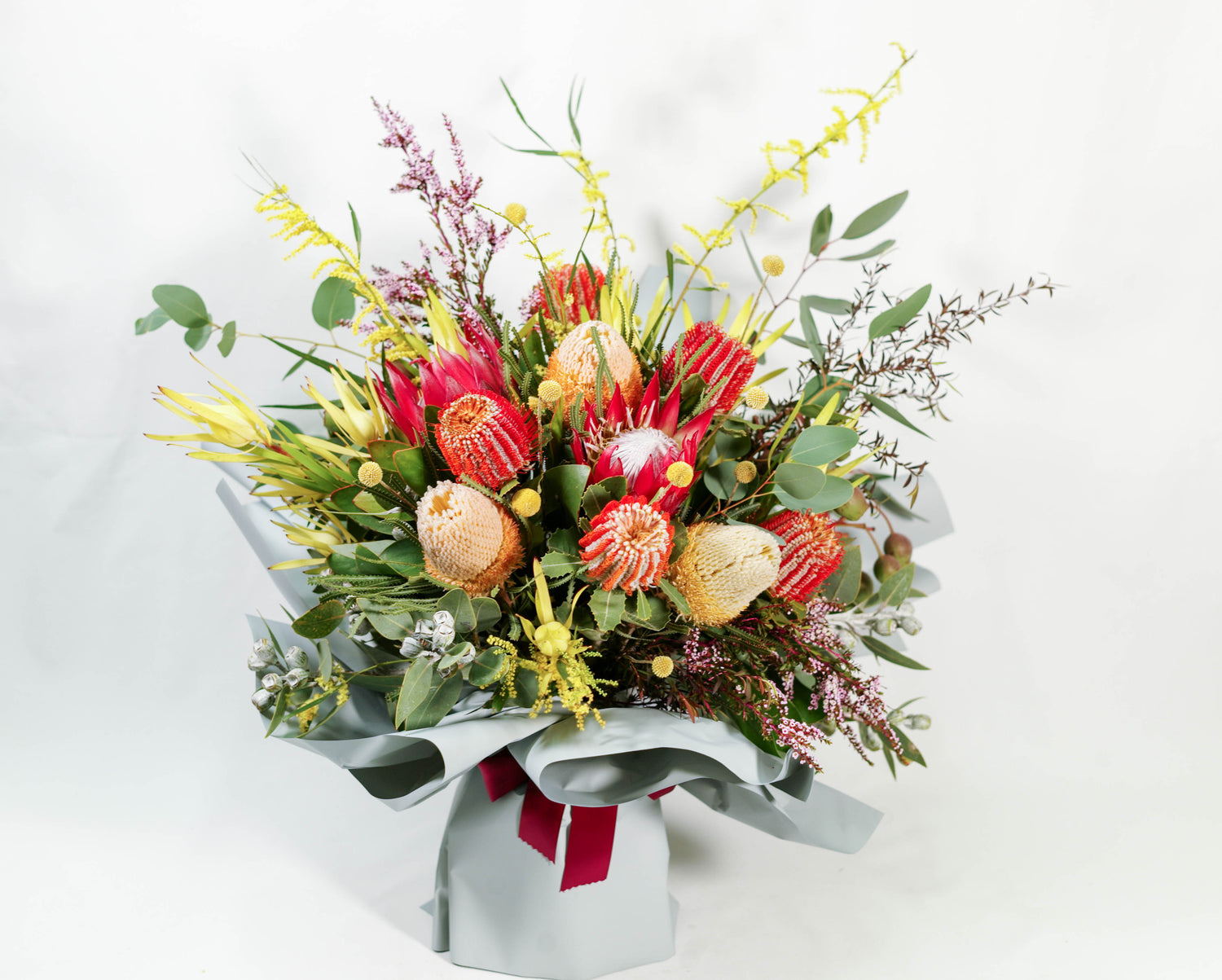Complementary flowers and foliage arranged with our finest Australian and South African native flowers